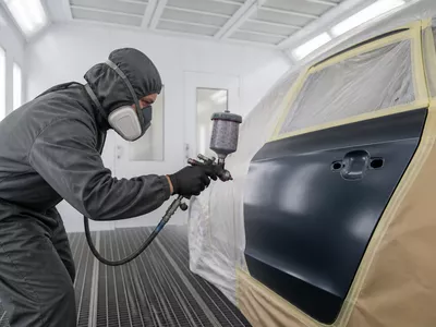 Car scratch and paint repair in an automotive respray booth